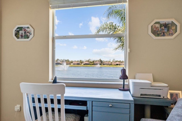 home office featuring a healthy amount of sunlight and a water view