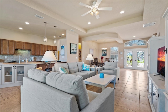 living room with light tile patterned floors, recessed lighting, visible vents, and french doors