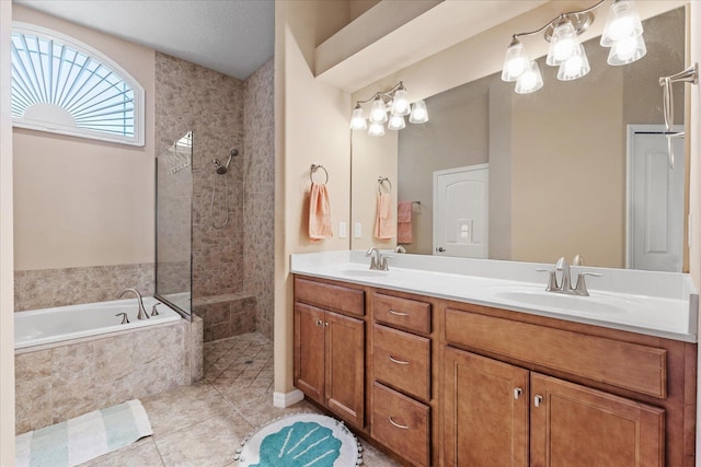 bathroom featuring double vanity, walk in shower, a sink, and a bath