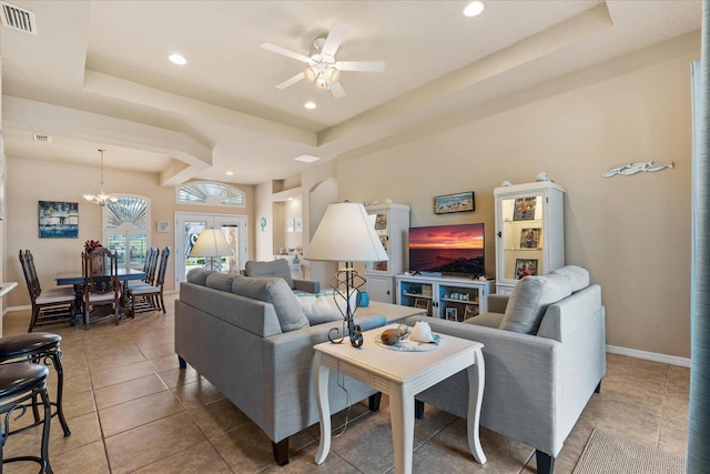 tiled living room with a tray ceiling, recessed lighting, visible vents, and baseboards