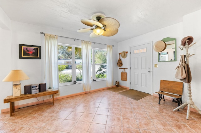 doorway to outside featuring light tile patterned floors and ceiling fan