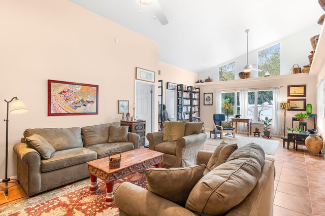 living area featuring ceiling fan, high vaulted ceiling, and light tile patterned floors