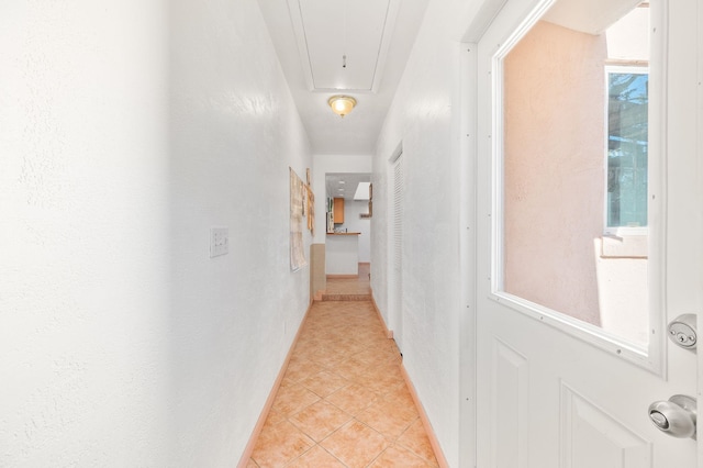 hall featuring light tile patterned flooring