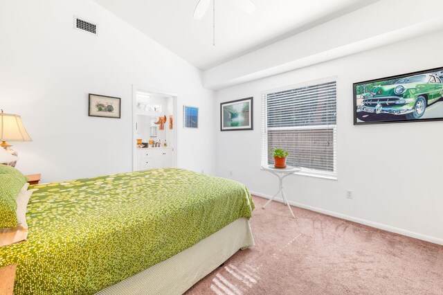 tiled bedroom featuring multiple windows, beamed ceiling, ceiling fan, and ensuite bath