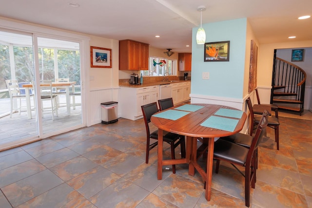 dining area featuring a wainscoted wall, stairway, and recessed lighting