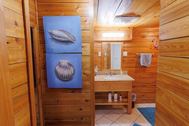 bathroom with tile patterned flooring, vanity, wooden ceiling, and wooden walls