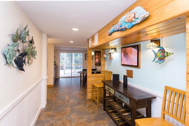 hall featuring wainscoting and recessed lighting
