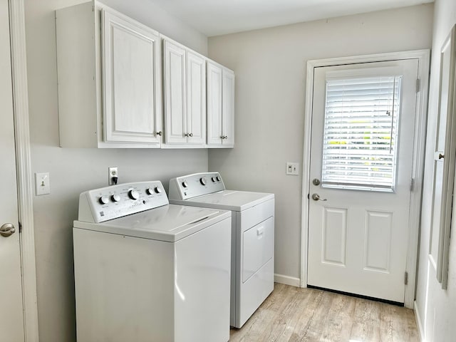 laundry room with light wood-style floors, cabinet space, separate washer and dryer, and baseboards