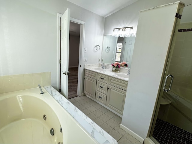 full bath with a sink, a tub with jets, a shower stall, and tile patterned floors