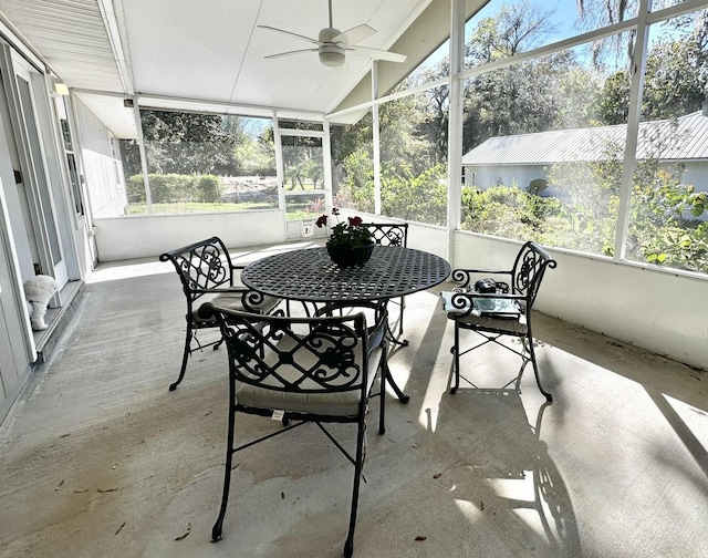 sunroom with plenty of natural light, ceiling fan, and vaulted ceiling