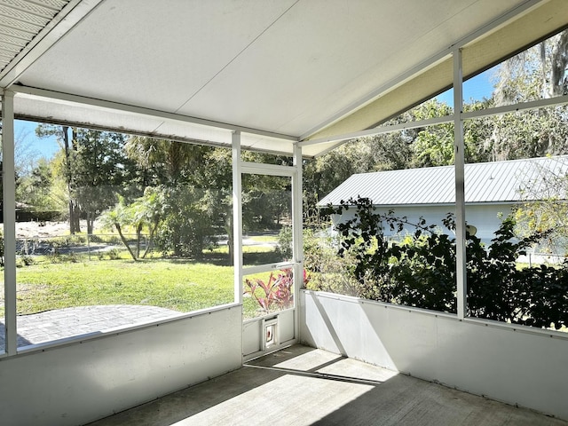 sunroom featuring vaulted ceiling