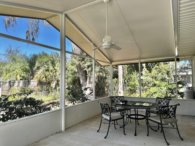 sunroom with a ceiling fan and vaulted ceiling