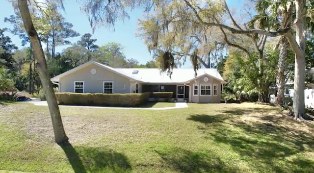 rear view of property featuring a yard