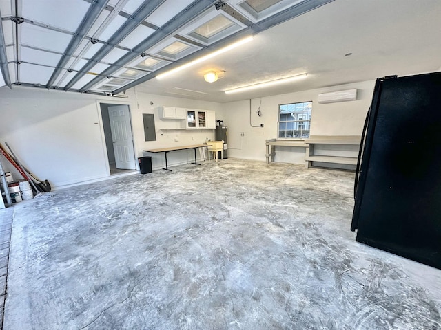 garage featuring a wall unit AC, electric panel, and freestanding refrigerator