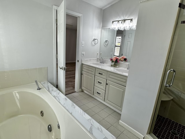 bathroom featuring double vanity, a whirlpool tub, a sink, tile patterned flooring, and a shower stall