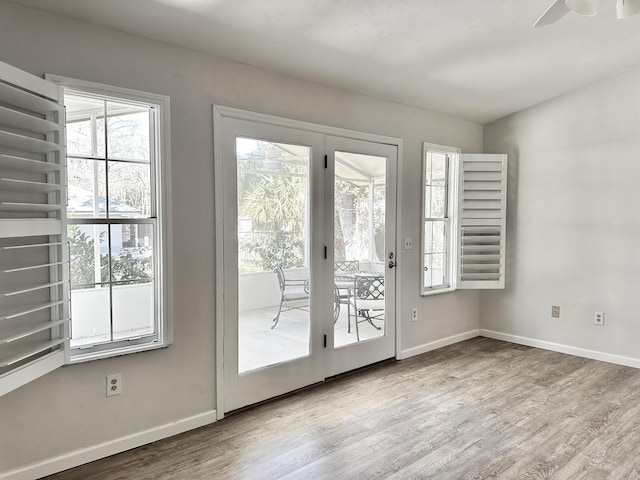 entryway featuring baseboards and wood finished floors