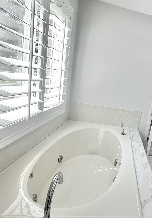 full bathroom with a jetted tub