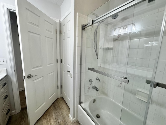 full bathroom featuring enclosed tub / shower combo, wood finished floors, and vanity