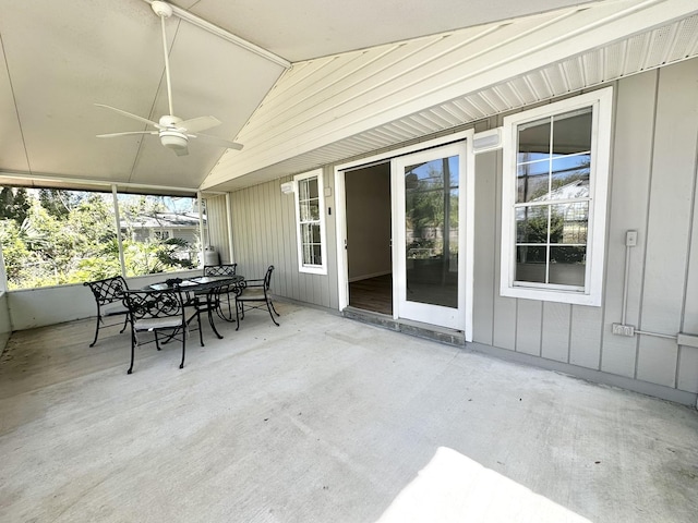 unfurnished sunroom with ceiling fan and lofted ceiling