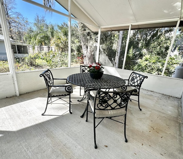 sunroom featuring lofted ceiling