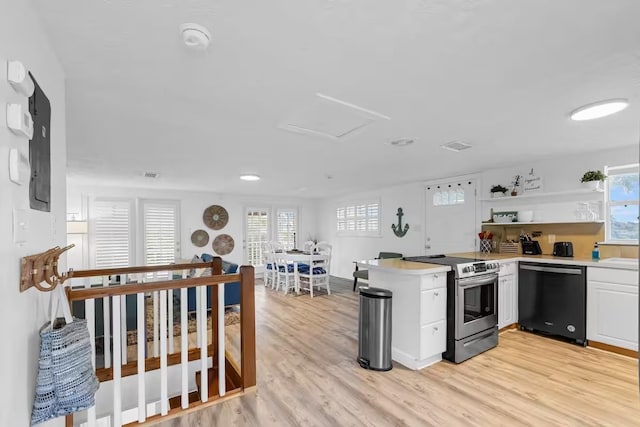 kitchen with kitchen peninsula, white cabinets, light hardwood / wood-style flooring, dishwasher, and stainless steel range with electric cooktop