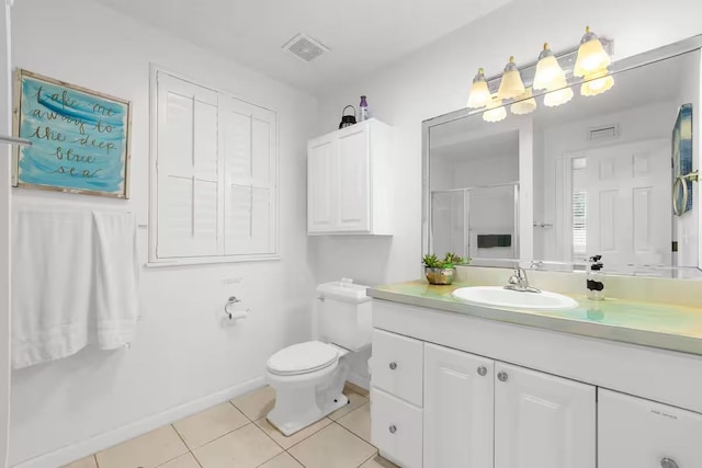 bathroom with toilet, vanity, tile patterned floors, and a shower with door