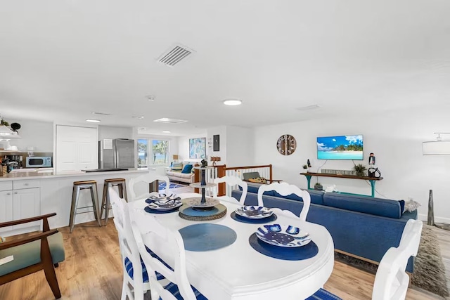 dining area with light hardwood / wood-style flooring