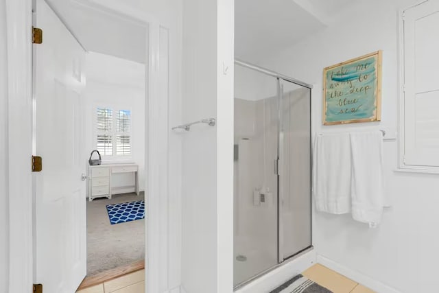 bathroom featuring tile patterned flooring, vanity, and walk in shower