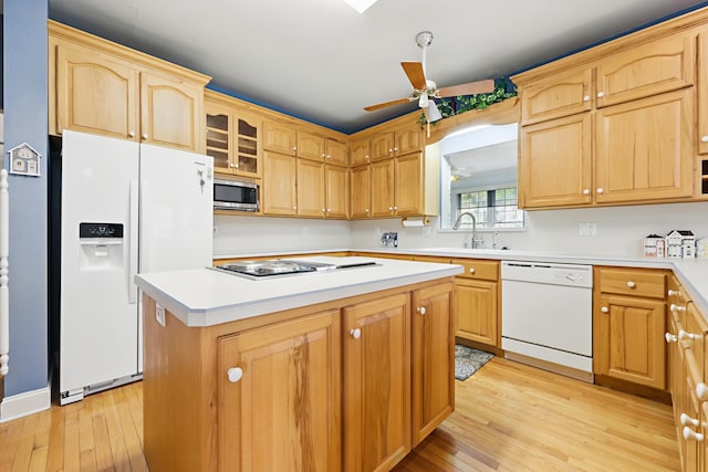 kitchen featuring light countertops, light wood-style floors, a ceiling fan, a sink, and white appliances