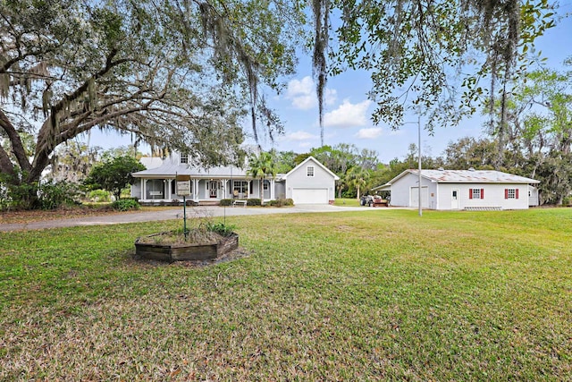 exterior space with driveway, covered porch, and a front lawn