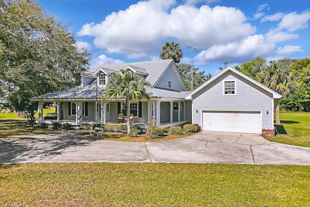 farmhouse-style home with covered porch, concrete driveway, and a front yard