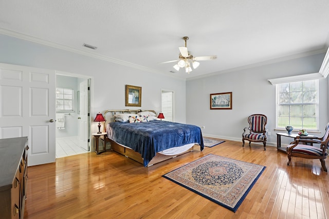 bedroom with light wood-style flooring, multiple windows, ornamental molding, and visible vents