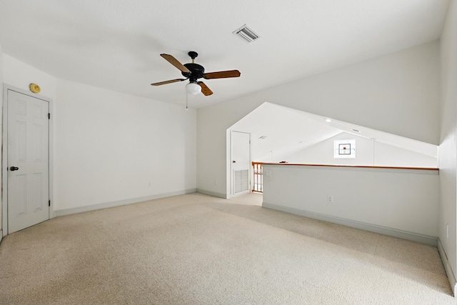 bonus room featuring ceiling fan, visible vents, baseboards, and light colored carpet