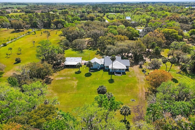 birds eye view of property with a forest view