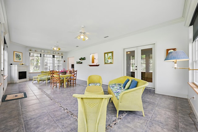 interior space with ceiling fan, french doors, a fireplace, and visible vents