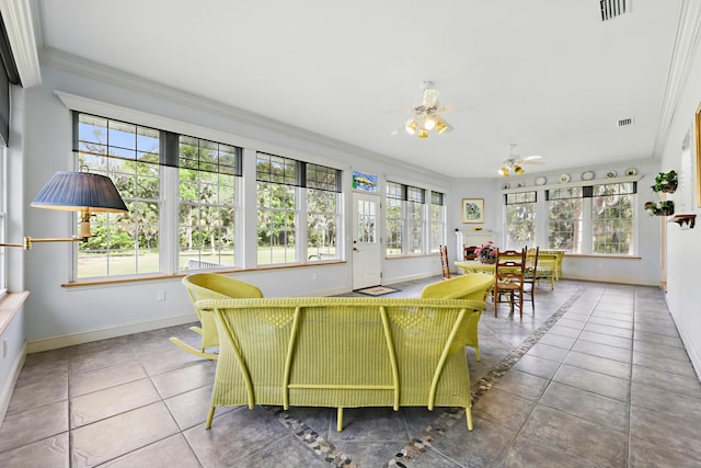 sunroom featuring plenty of natural light, visible vents, and a ceiling fan