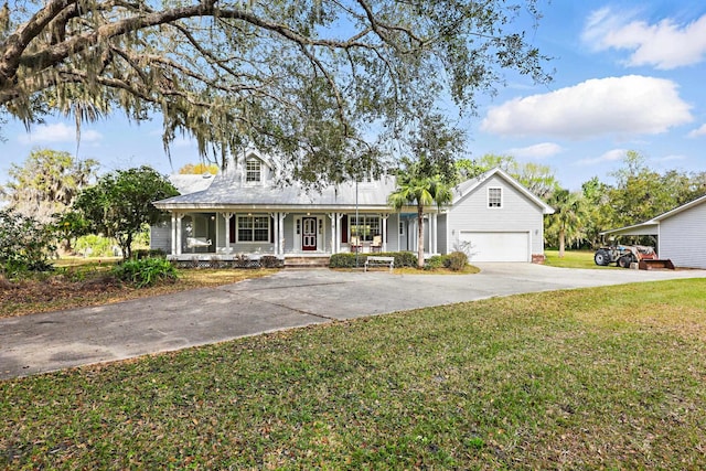 view of front of home featuring a garage, covered porch, driveway, and a front lawn