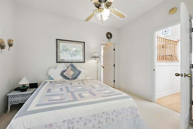 bedroom with light carpet, baseboards, and a ceiling fan