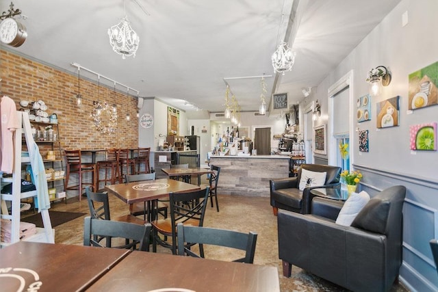 dining space featuring brick wall