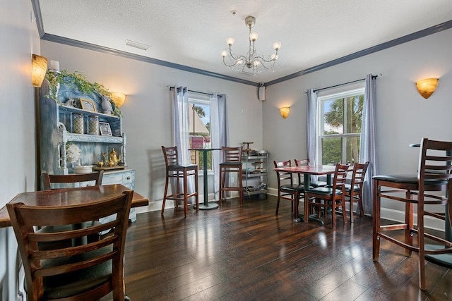 dining room featuring a textured ceiling, a notable chandelier, dark hardwood / wood-style floors, and ornamental molding