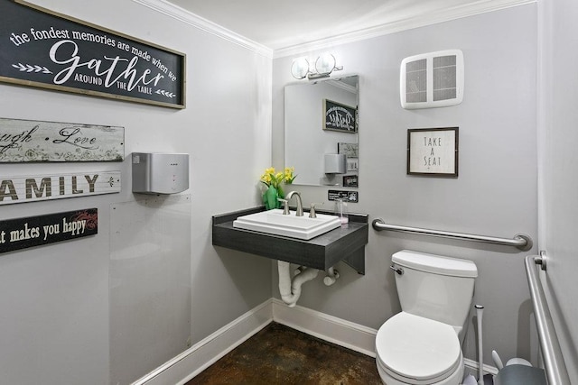 bathroom featuring toilet, ornamental molding, and sink