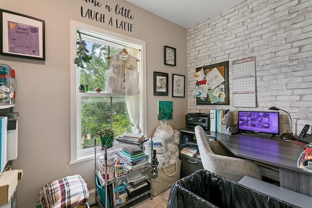 office area with a wealth of natural light and brick wall