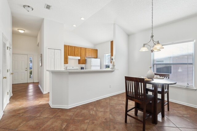 tiled dining space with high vaulted ceiling, a textured ceiling, and an inviting chandelier