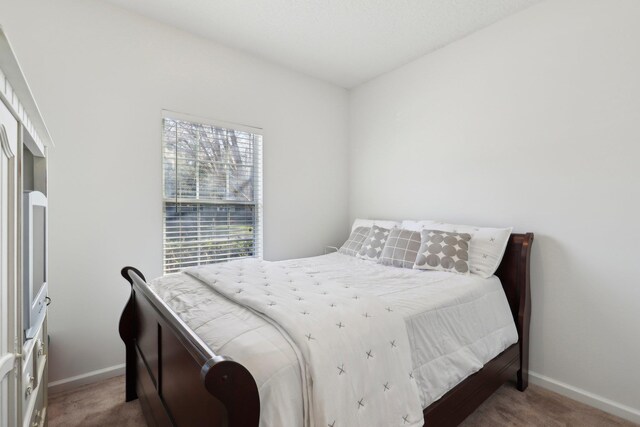 bedroom featuring light colored carpet