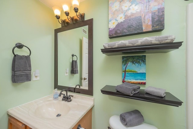 232 Riberia St, Saint Augustine, FL 32084 - bathroom with toilet, vanity, visible vents, and a chandelier