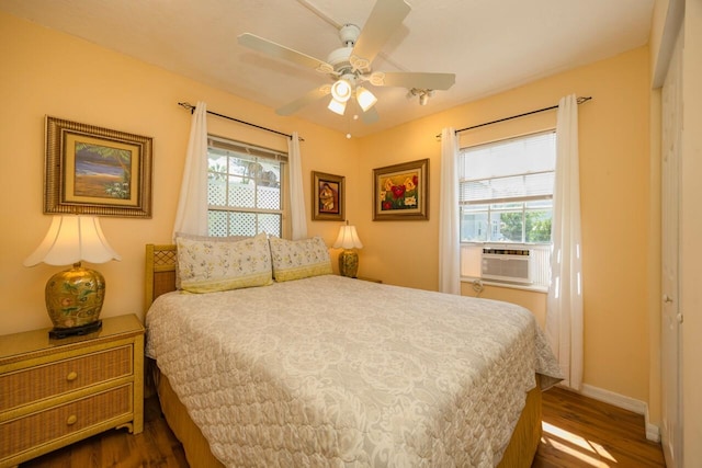 232 Riberia St, Saint Augustine, FL 32084 - bedroom with baseboards, multiple windows, cooling unit, and dark wood-type flooring