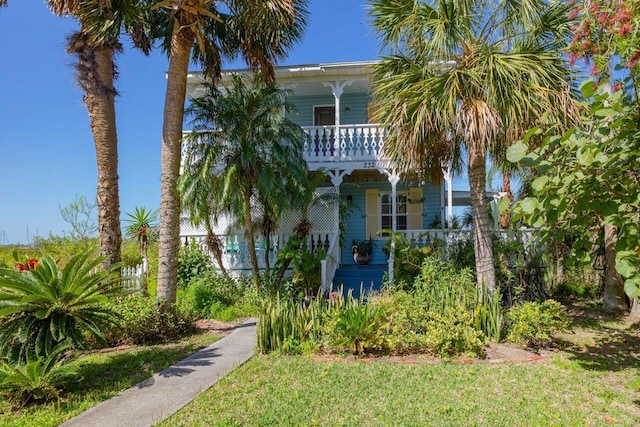 232 Riberia St, Saint Augustine, FL 32084 - view of front of property with a balcony, a front lawn, and covered porch