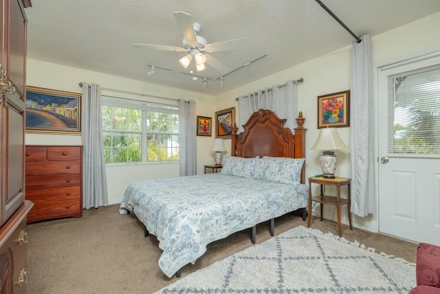 232 Riberia St, Saint Augustine, FL 32084 - carpeted bedroom featuring track lighting, a textured ceiling, and ceiling fan