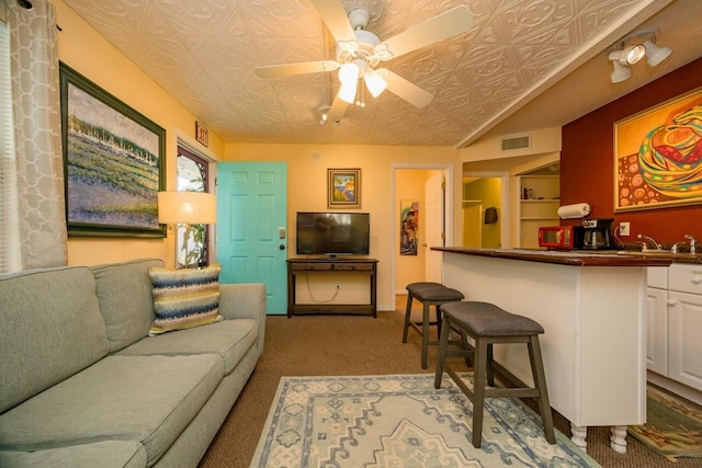 232 Riberia St, Saint Augustine, FL 32084 - carpeted living area featuring baseboards, an ornate ceiling, visible vents, and a ceiling fan