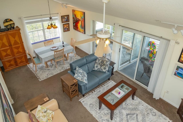232 Riberia St, Saint Augustine, FL 32084 - living area with a textured ceiling, track lighting, an inviting chandelier, carpet flooring, and baseboards